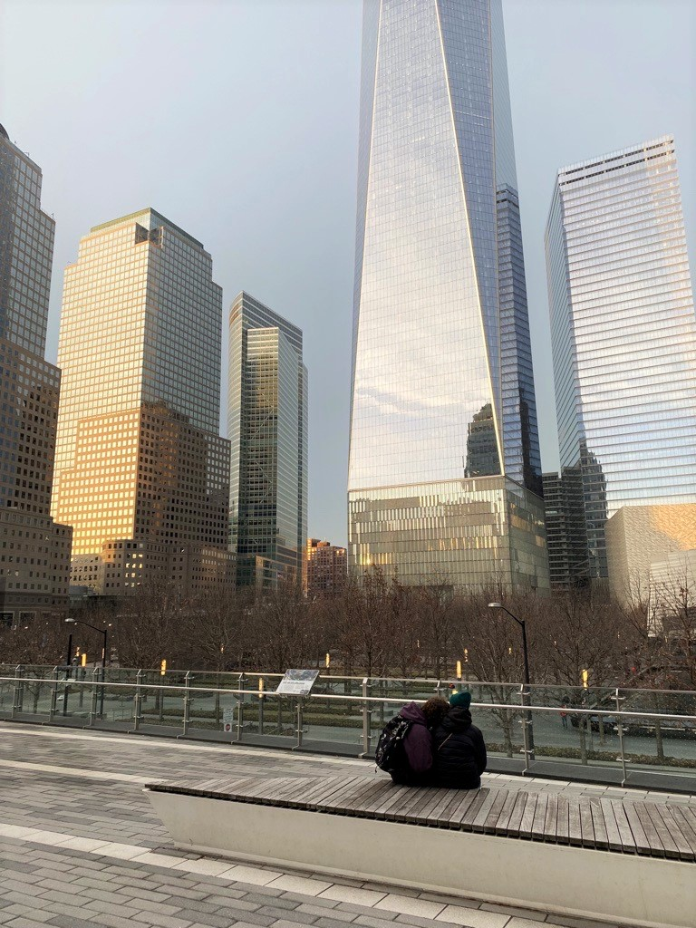 Two people sitting and looking at One World Trade Center