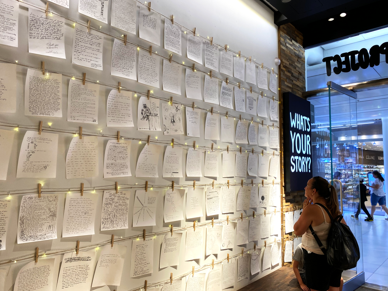 strangers project space in world trade center with stories written on wall